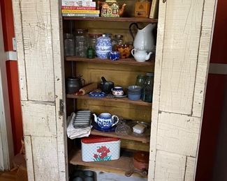 Antique cabinet full of antique/vintage kitchen items, containers, cookbooks & utensil.