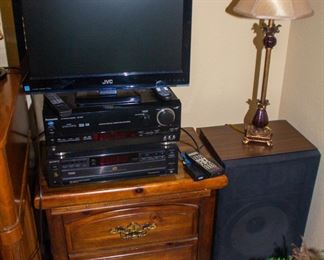 JVC TV, Panasonic media player, Sony media player, speakers, wooden end table with drawers