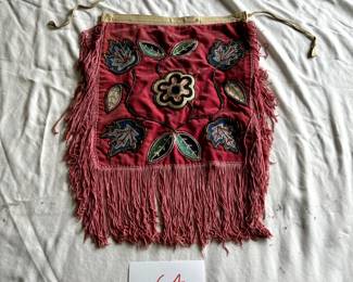 $750 - $1,000.  Native American beaded cloth, floral motif (early 20th century) (band detatched).  Measures 16" by 19".