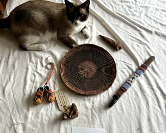 $250 - $500.	Native American beaded pipe, moccasins, arrowhead, and African? basket (cat not included!)