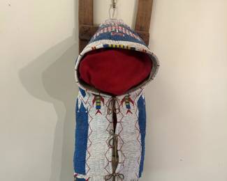 Inquire.	Traditional Native American beaded cradleboard, blue and white.  Measures approximately 35" by 15".