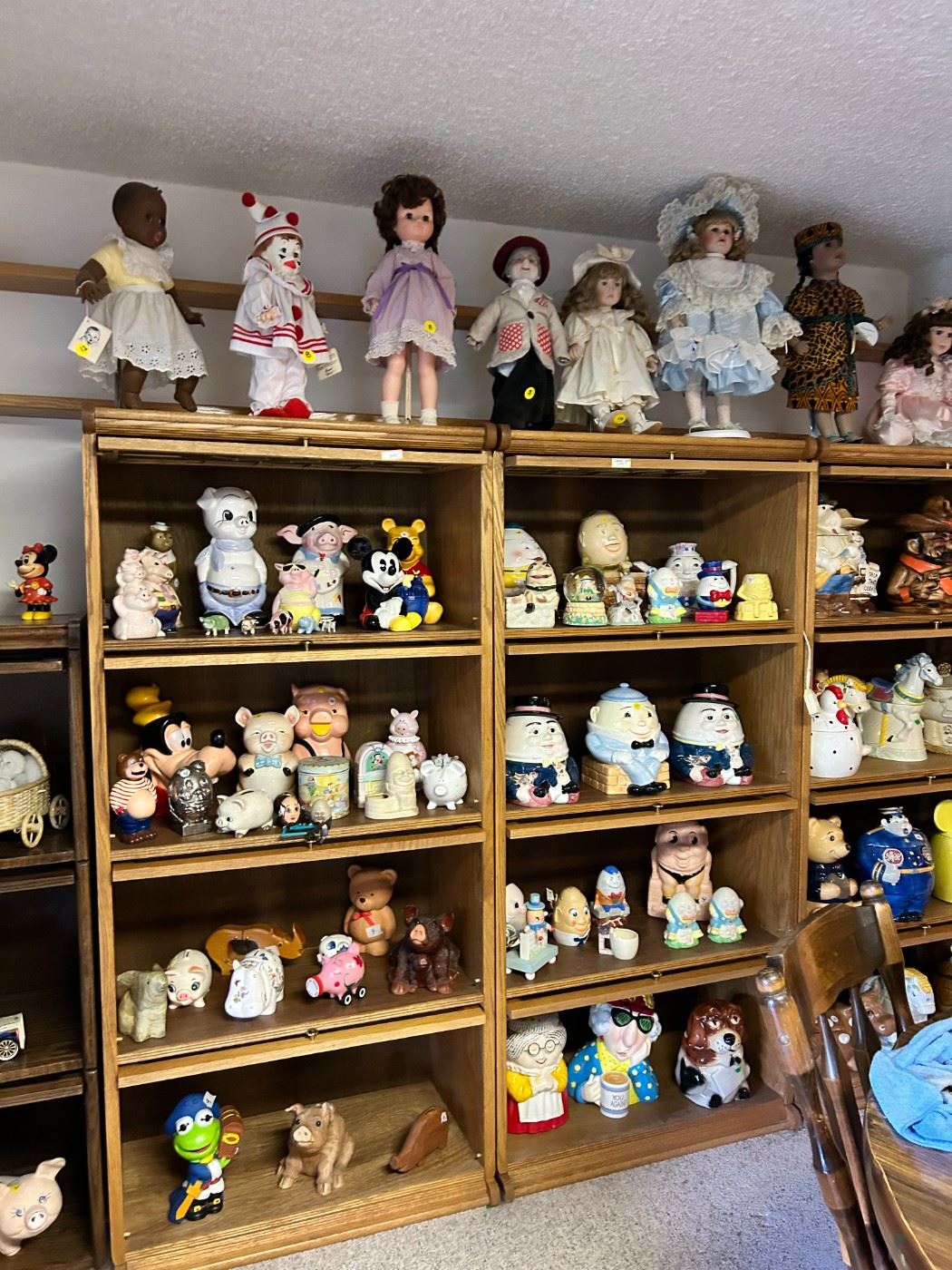 There are 8 oak lawyer stack bookcases, all as new. Each bookcase has collectible cookie jars, Fitz & Floyd, Treasurecraft, and Disney. Oak lawyer Cabinets retailed for around $1,200. leaded  glass on the top sections Asking price is $295.00.