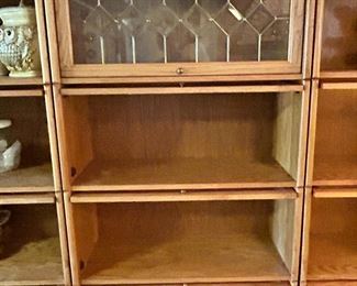 There are 8 of these oak stack bookcases downstairs with all the cookie jars in them. Leaded upper cabinet. They sold for around $1,200 new each. Priced at 275.00 each.  New condition. Downstairs. 
