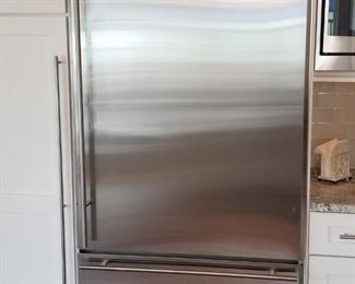 GE counter depth Monogram stainless steel fridge; small dent on right side of fridge door 