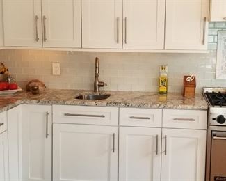 Clean & contemporary kitchen with lots of 42" upper cabinets; wood painted white