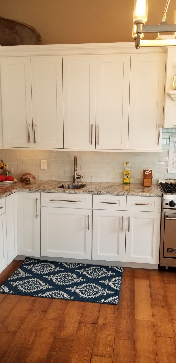 Clean & contemporary kitchen with lots of 42" upper cabinets; wood painted white