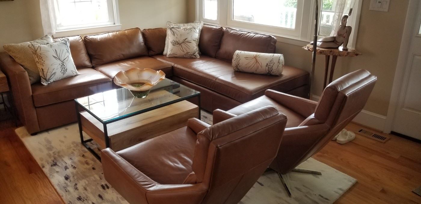 Stunning Marin contemporary leather couch with two matching Austin swivel chairs. Made by West Elm
leather two-piece bumper chaise sectional is a must see! Less than three years old!!! Coffee table is West Elm  Industrial living room collection.