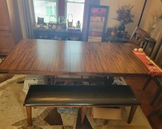 74" x 44" expandable to 92' X 44" beautiful Trestle dining room table! It has a hidden leaf that hides inside the table and can be accessed by pulling both sides of the table apart. Comes with 6 Chairs and one bench.