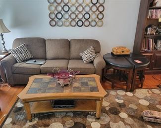 Coffee table with two matching end tables. Stone tiles, wood with metal accents. Very Good Condition.