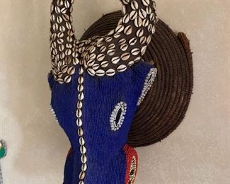 Mounted African water buffalo mask with glass beads and cowrie shells
