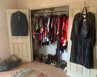 A closet full of designer and folk art clothing, shoes and boots, handbags and scarves