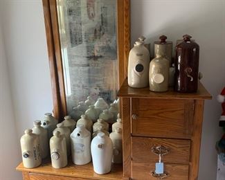 Collection of antique stoneware hot water bottles and dresser