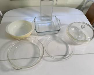 Group of glass pie pans, juice bottle and casseroles