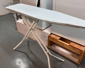 Ironing board with iron stand attachment at end