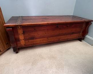 Cedar chest with copper straps, some wear, on casters 16"H x 48"W x 18"D