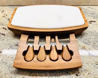 Teak cheese board with hidden drawer of serving utensils 