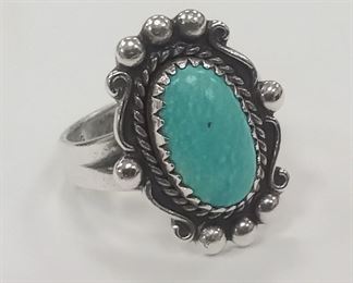 A SMALL STERLING RING WITH BLUE CABOCHON TURQUOISE COLOR STONE.  SIZE 4 3/4