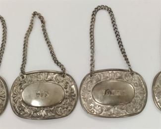 SET OF FOUR SILVER PLATED LIQUOR BOTTLE TAGS, FOR GIN, VODKA, SCOTCH AND BOURBON.  PLATES ARE 2 3/8" x 1.75"