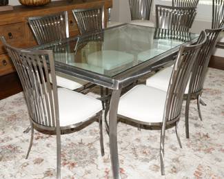Polished chrome & leather chairs with an adjustable glass top dining table.  This item is being sold as a set-quite incredible really!