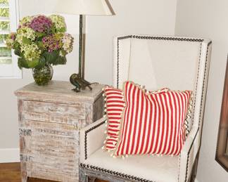 Distressed upholstered accent chair with matching distressed side cabinet 