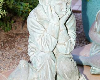 Stone little boy yard bronze by Jay Saylors