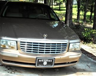 1998 Gold Cadillac Deville.  White leather interior