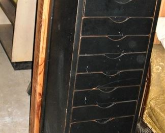 Tall wooden storage fie cabinet on rollers.