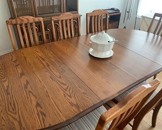Solid oak table, two leaves, 8 chairs.  Made by Amish