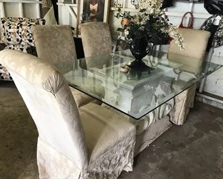 Glasstop table with four upholstered chairs