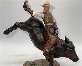 Cowboy riding bronco sculpture