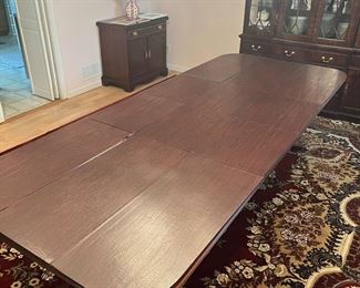 Fully expanded Thomasville formal dining table with full padded covers