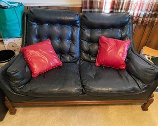 Fabulous faux leather loveseat with red pillows