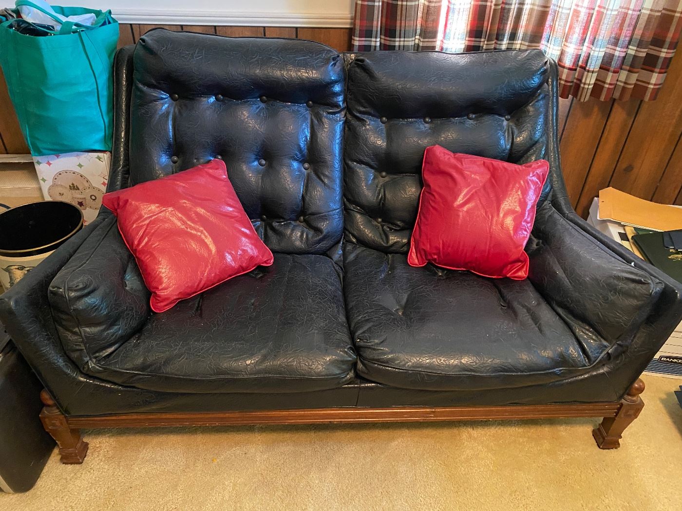 Fabulous faux leather loveseat with red pillows