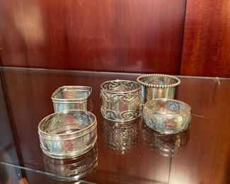 $100 	
Sterling lot of napkins rings (5) 