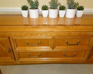 Elegant hand varved wood inlaid buffet.  Those are faux cactus plants on top, easy to grow and maintain.