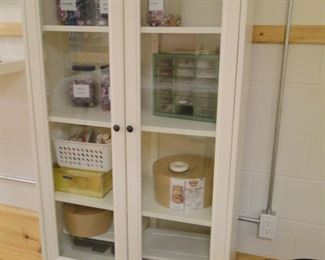 Tall, white storage cabinet, plenty of storage and everything can be seen quickly