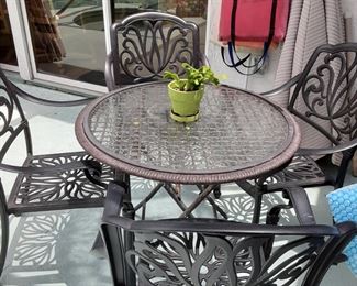 Metal Chairs & Table that Folds Up. Has a hole for an umbrella