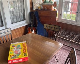 vintag emaple table and metal chairs , vintage board games and very nice guitar 