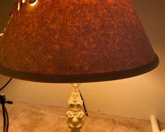 pair of iron based lamps with a cut work paper shade