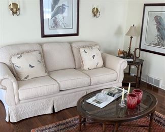 Custom upholstered sofa,  Audubon Prints, vintage area rug, coffee table