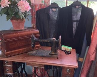 Antique, Standard sewing machine, fabric bolts,  women’s clothes