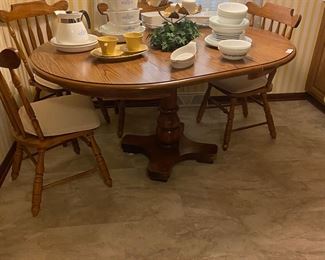 Beautiful oak pedestal table with one leaf and four side chairs. Several pieces of Corning ware are available also.