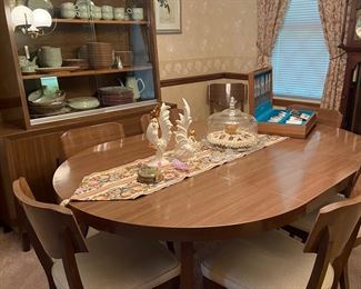 Mid Century Modern table with two leaves and eight chairs.