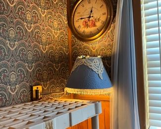 Clock, wall lamp in bedroom