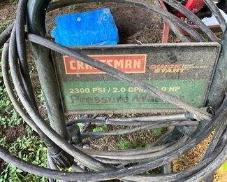 Behind the house under the canopy - power washer 