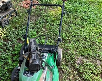 Behind the house under the canopy - lawn mower