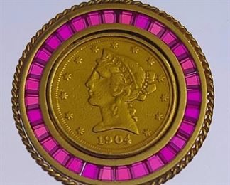 1904 Liberty $5 gold coin set in a 14k yellow gold setting with bezel set Ruby Gemstones.