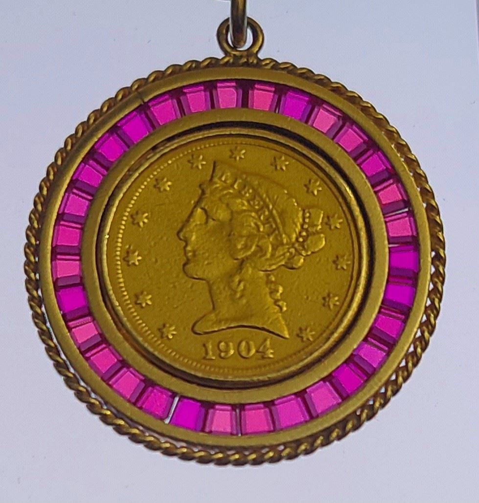 1904 Liberty $5 gold coin set in a 14k yellow gold setting with bezel set Ruby Gemstones.