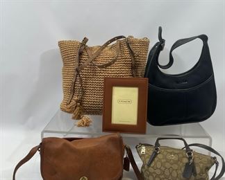 Large Ralph Lauren Straw Hayden Tote with snap closure. The Ralph Lauren bag is 15 inches wide by 6 inches deep by 12 inches high. Coach vintage leather British tan city bag. Two way mini Kelsie crossbody signature C brown canvas and brown leather bag with zipper closure. Black neoprene Coach shoulder bag with zipper closure. Coach leather picture frame.
