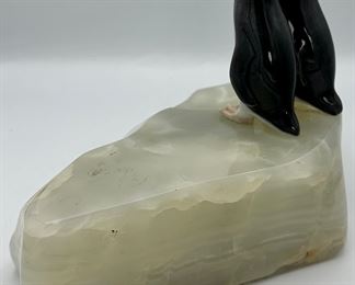 Awe...Two penguins smooching on the side of a slab of onyx.  We believe the penguins are Royal Copenhagen and were attached to this onyx rock specimen.  Clever.